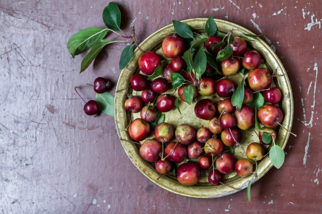 Rustic Apple & Cherry Arrangement on Vintage Plate - Wallpaper Background