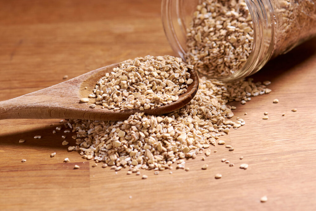 Rustic Wallpaper of Oatmeal Spilled from Glass Jar on Wood Surface