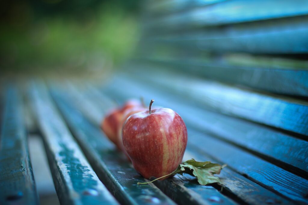 Rustic Wallpaper: Ripe Red Apple on Weathered Wooden Bench