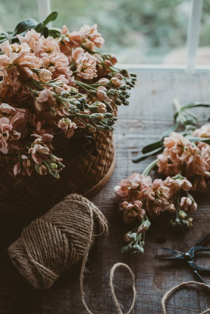 Rustic Wallpaper with Soft Pink Flowers & Cozy Craft Essentials