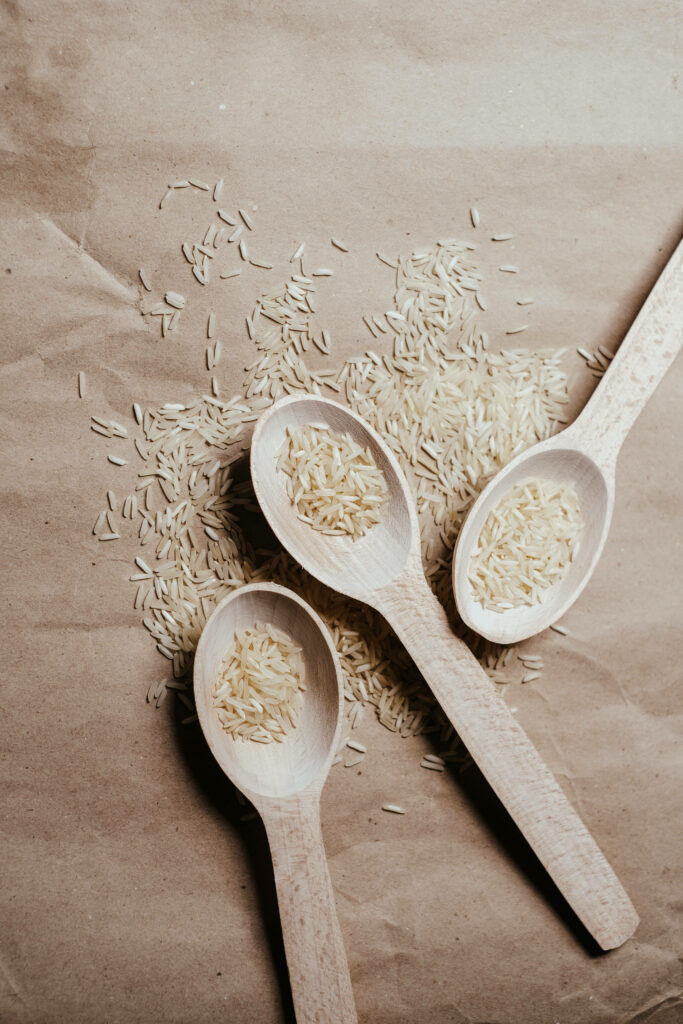 Earthy Rustic Wallpaper: Wooden Spoons with Varieties of Raw Rice