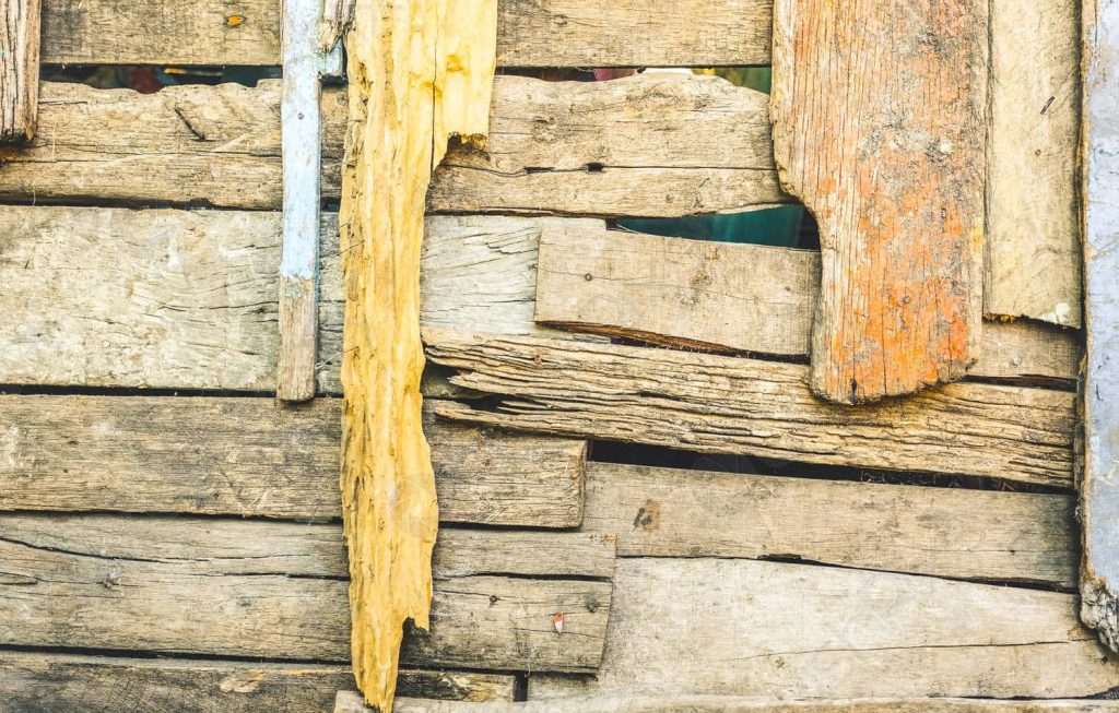 Rustic weathered wooden planks wallpaper with vintage texture and faded yellow paint panels