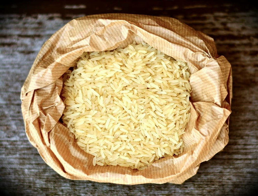 Close-Up of White Rice Bag on Rustic Wood: Wallpaper Background