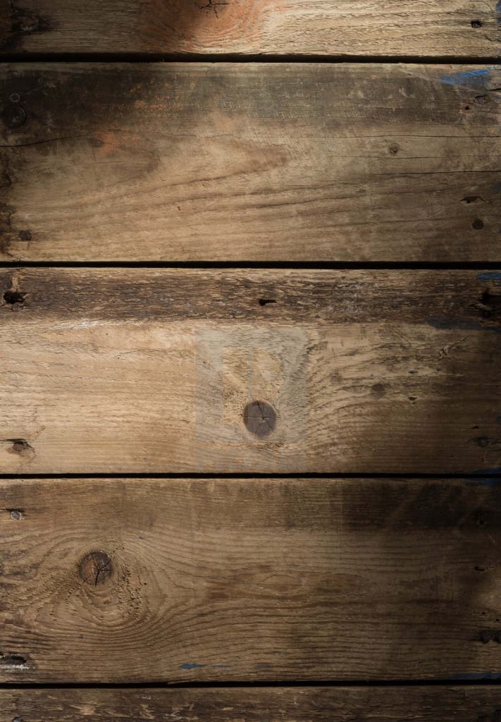 Rustic wood panel wallpaper with weathered planks and soft light highlighting grain texture