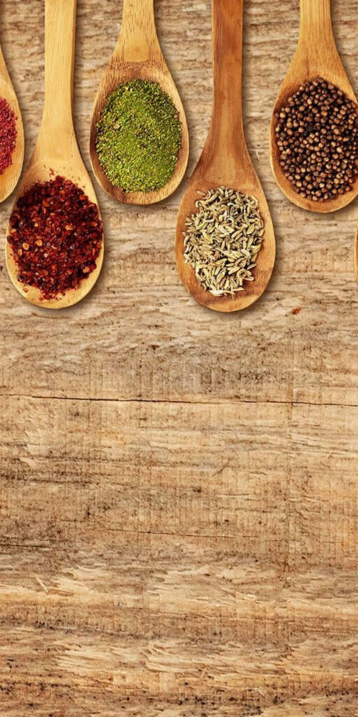 Rustic Wooden Wallpaper: Colorful Spices & Food Powders Display