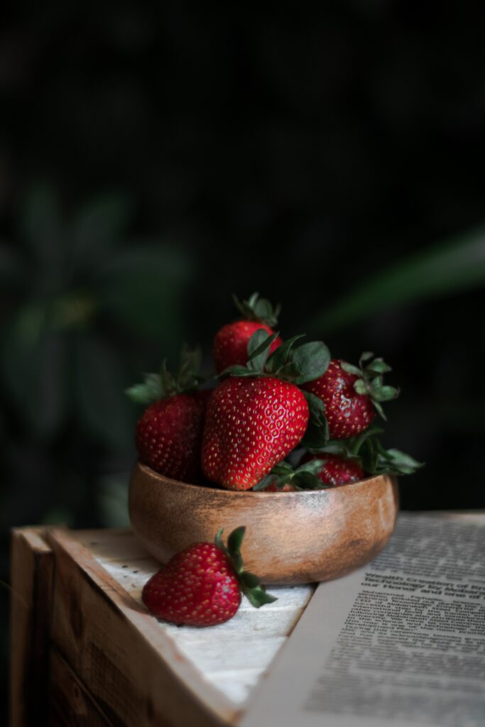 Rustic Wooden Bowl of Fresh Strawberries - Inviting Wallpaper Background