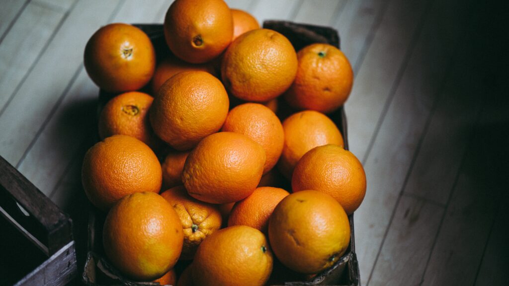 Rustic Wooden Box with Fresh Oranges - Vibrant Wallpaper Background