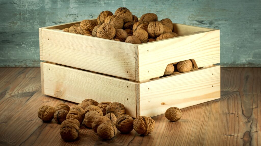 Rustic Wooden Box of Unshelled Walnuts: Natural Wallpaper Background