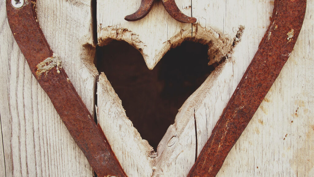 Vintage Rustic Wooden Heart Carving with Weathered Textures Wallpaper