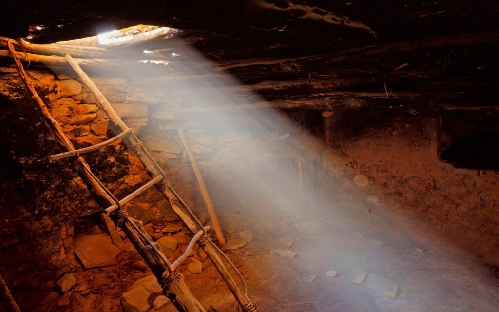 Rustic wooden ladder against stone wall in old mine with dramatic light beams and shadows wallpaper