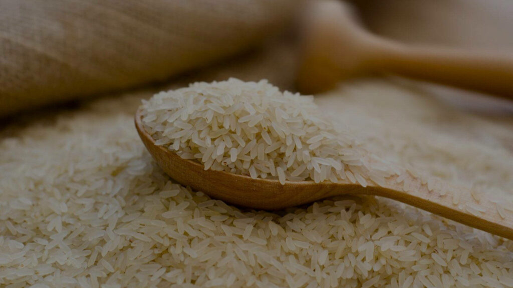 Rustic Wooden Spoon & Uncooked Rice: Natural Wallpaper Background