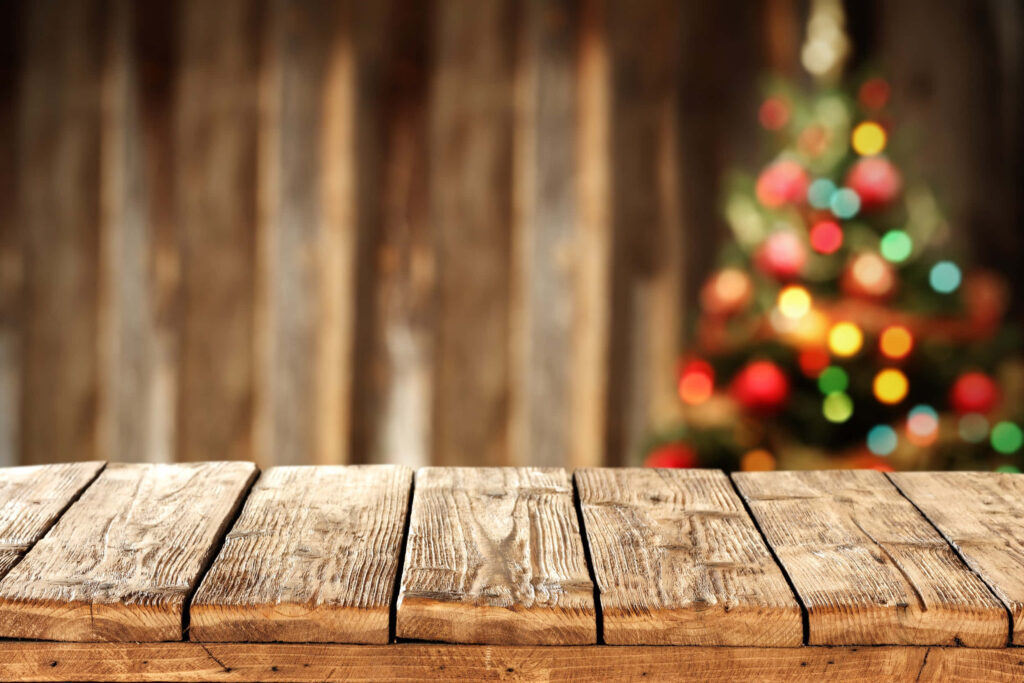 Rustic Wooden Table with Blurred Colorful Christmas Tree Wallpaper