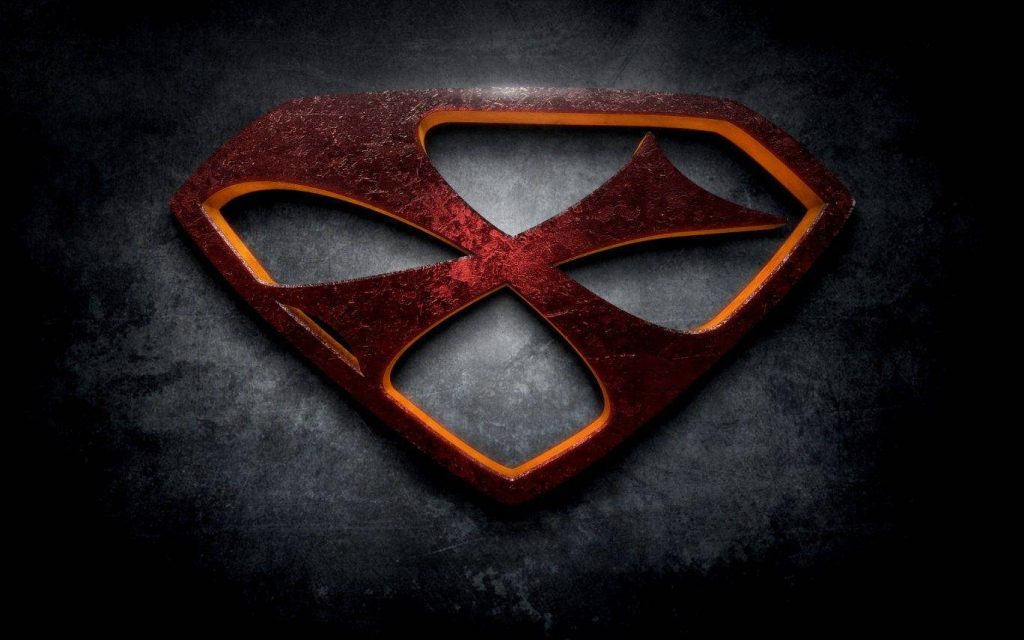 Stylized X logo in rusted diamond metal crest with glowing edges on gritty dark red background Wallpaper
