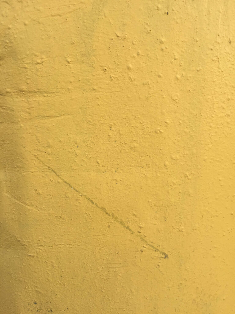 Rustic Yellow Textured Wallpaper Background with Subtle Imperfections