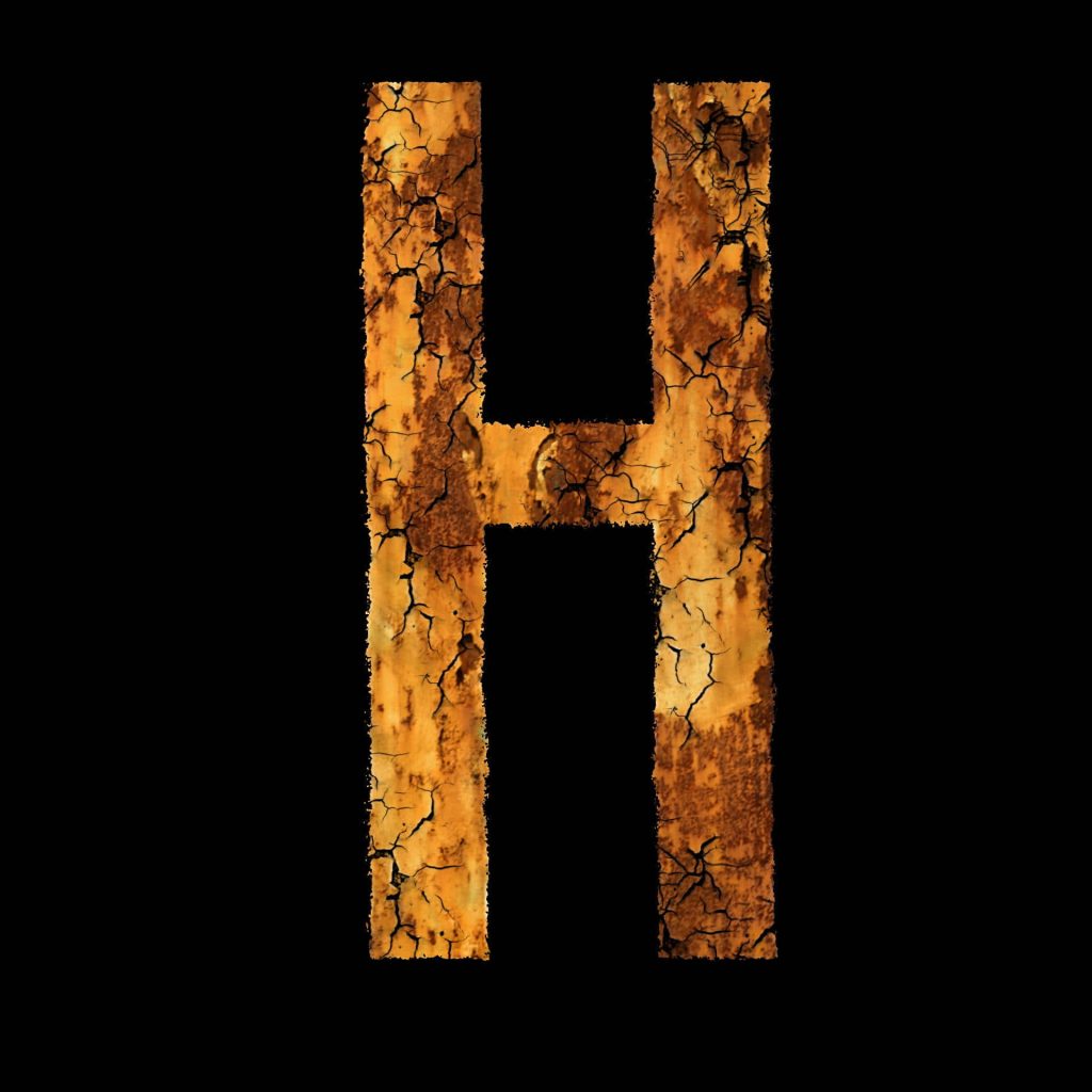 Distressed rusty brown letter H with intricate cracks on black grunge industrial wallpaper background