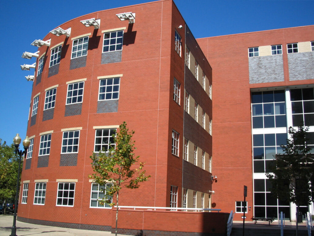 Rutgers Bloustein Building red brick facade large windows sharp lines clear blue sky wallpaper