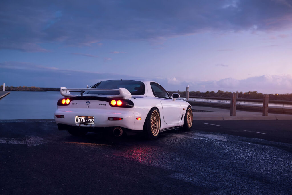 Twilight Serenade: Majestic White Rx-7 by the Waterside Wallpaper