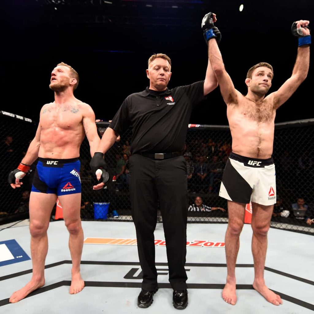 UFC fight decision Ryan Hall victorious referee raises arm Gray Maynard standing Octagon action Wallpaper
