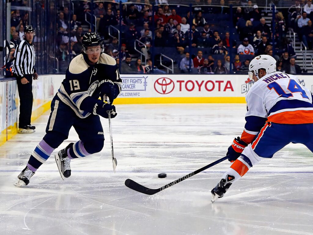 Ryan Johansen battles Columbus Blue Jackets in intense hockey game action on vibrant ice rink background Wallpaper