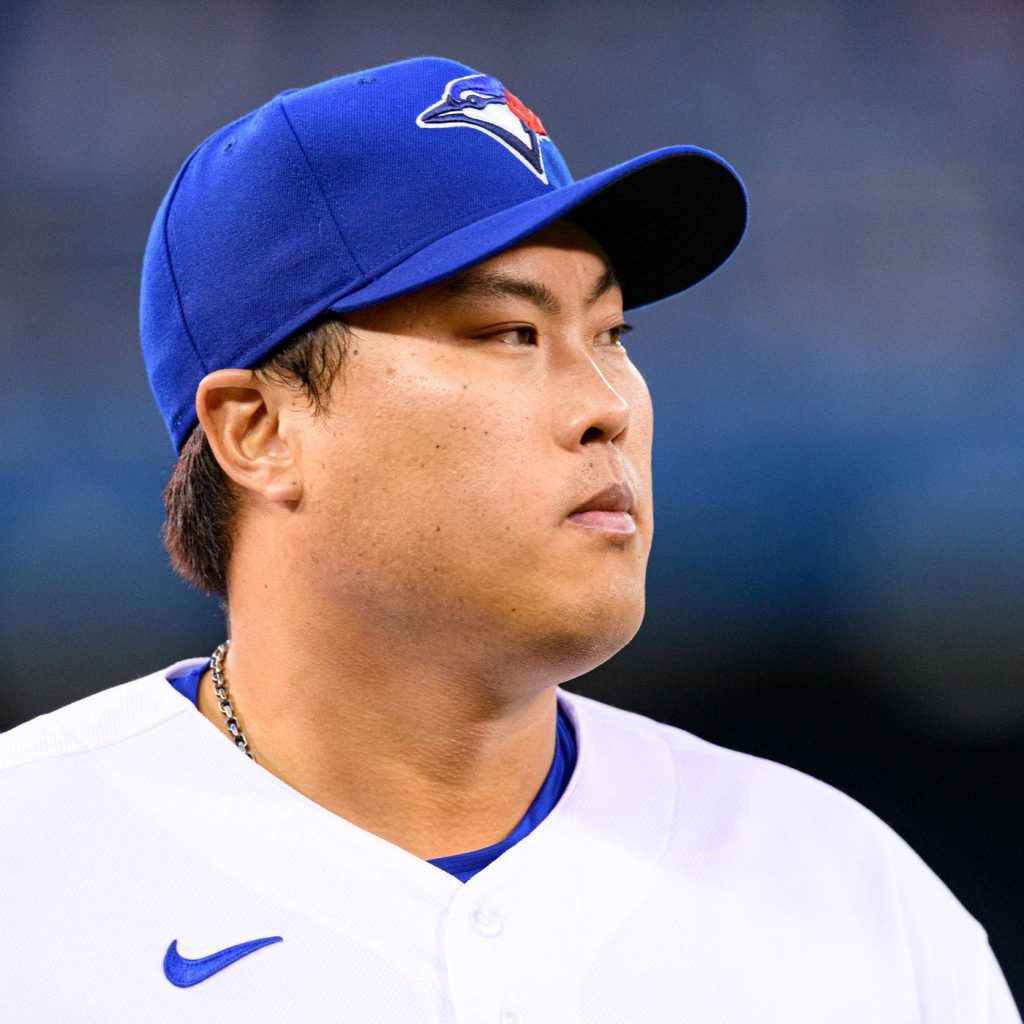 Toronto Blue Jays pitcher Ryu Hyun-jin focused close-up in white jersey and blue cap wallpaper