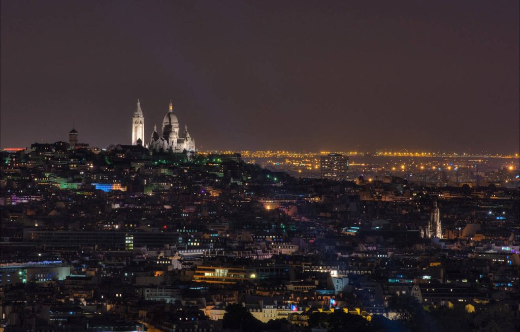 Illuminated Sacré-Cœur Basilica at night over Montmartre Paris cityscape wallpaper background
