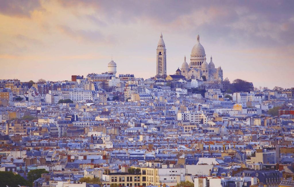 Sacré-Cœur Basilica overlooking Montmartre rooftops at golden sunset paris cityscape wallpaper background