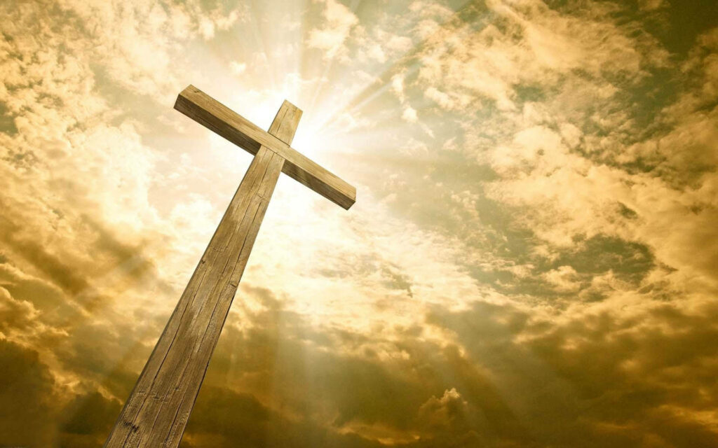 Radiant Redemption: A Sunlit Cross Wallpaper