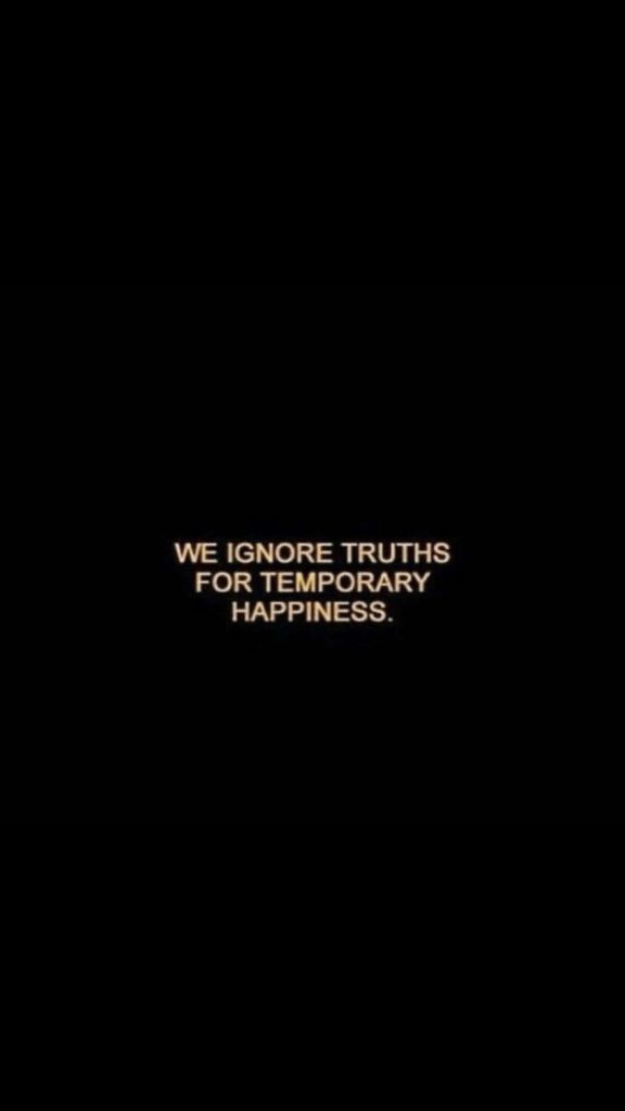 Minimalist wallpaper with sad quote We ignore truths for temporary happiness on black background