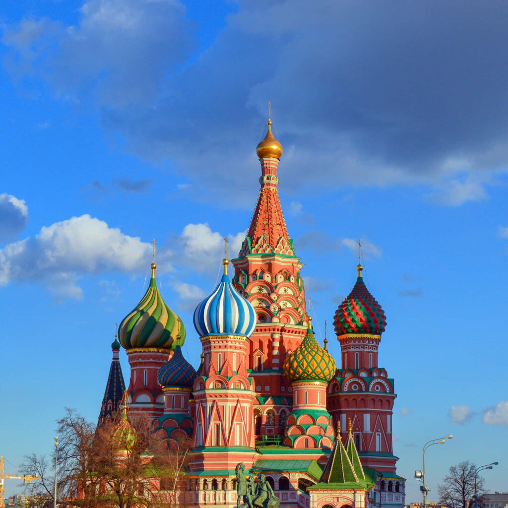 Saint Basils Cathedral colorful domes under dramatic dark clouds in Moscow skyline background Wallpaper