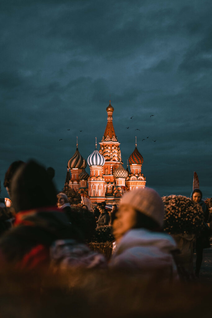 Saint Basils Cathedral illuminated at night Moscow with people and dramatic evening sky background Wallpaper