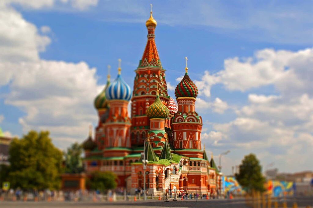 Softly blurred Saint Basils Cathedral with colorful domes under bright sky wallpaper background