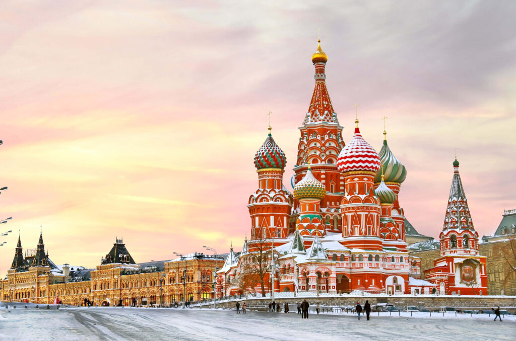 Saint Basils Cathedral in Moscow with colorful domes covered in snow under pastel evening sky Wallpaper