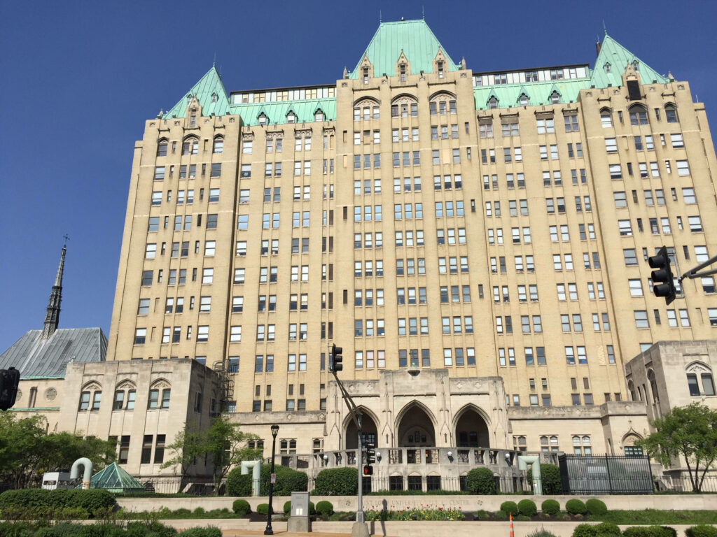Saint Louis University Hospital facade with Gothic Revival architecture and green copper roof Wallpaper