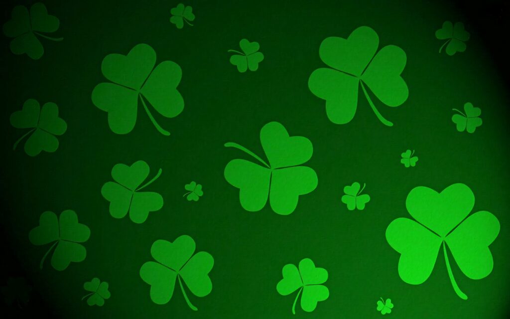 Bright green shamrocks on textured deep green fabric background Saint Patricks Day wallpaper