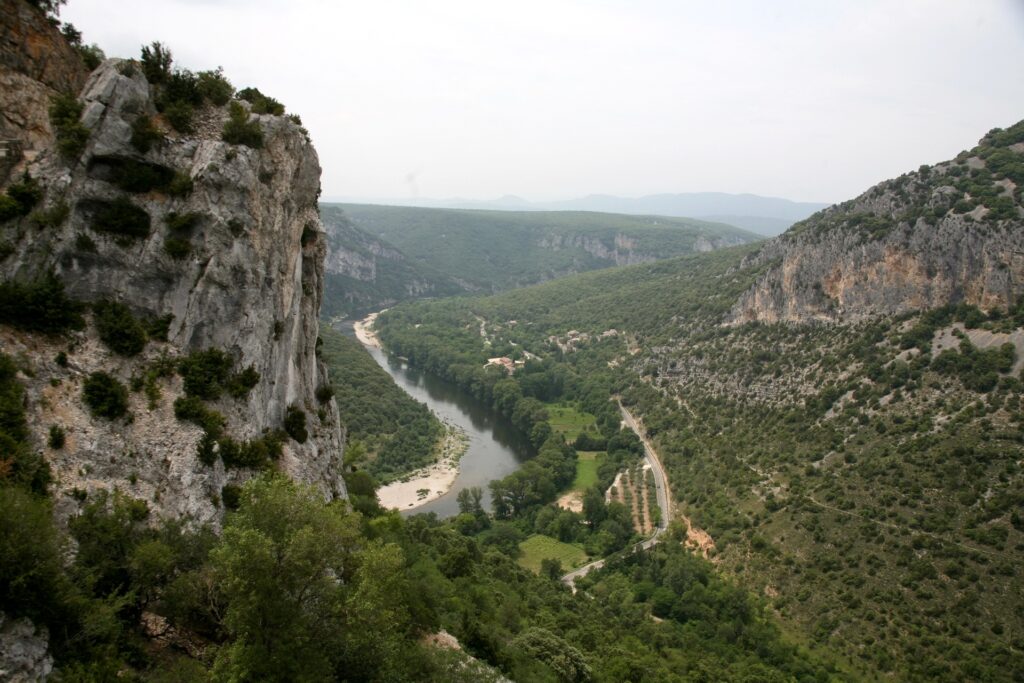 Scenic Saint-Remez France wallpaper with rugged cliffs lush green mountains and winding river valley