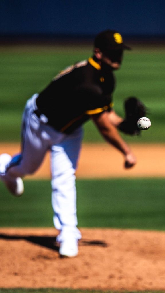 San Diego Padres pitcher in brown gold uniform mid-pitch with baseball in flight MLB wallpaper