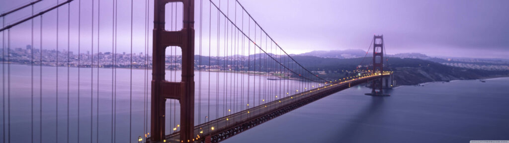 Gateway to the Golden Coast: Majestic San Francisco Bridge Embracing Clear Bay and Ethereal Cloudscape Wallpaper