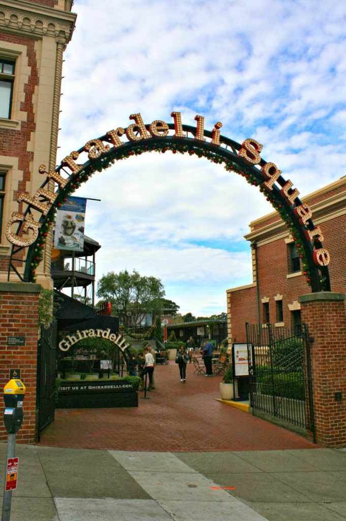 Ghirardelli Square entrance arch with festive garland and red brick in San Francisco plaza Wallpaper