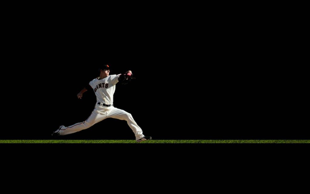 San Francisco Giants pitcher mid-pitch on grass field high-contrast dynamic baseball wallpaper