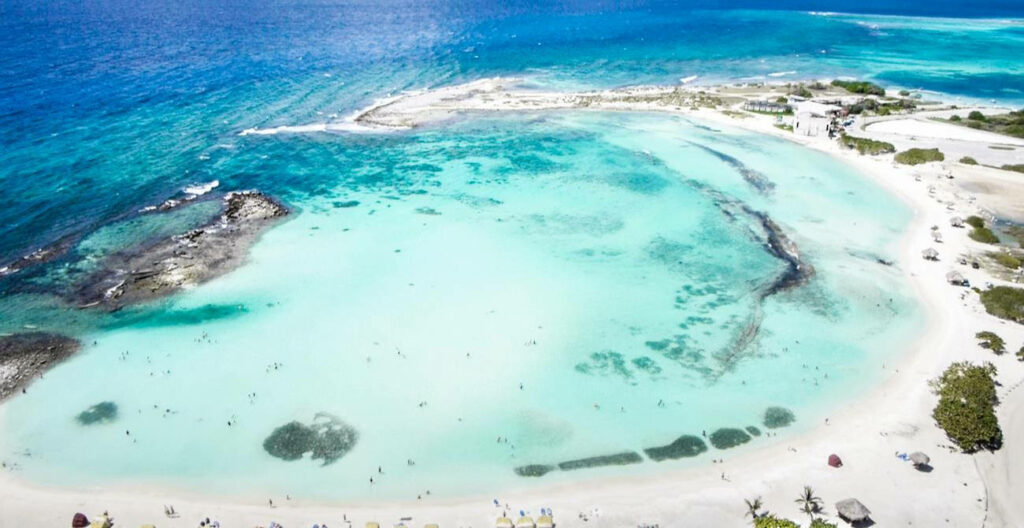San Nicolas Serenity: A Captivating Aerial Snapshot of Aruba's Sandy Baby Beach and Turquoise Waters Wallpaper