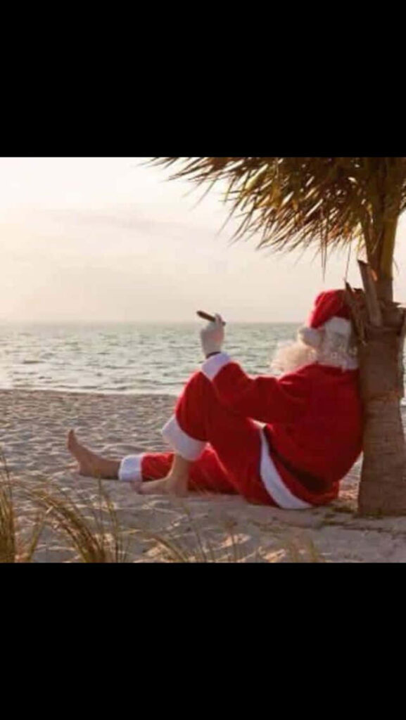 Santa Claus Relaxing on a Beach: A Humorous Holiday Wallpaper