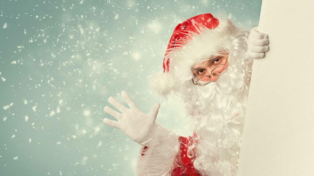 Santa Waves in Cheerful Snowfall - Festive Holiday Wallpaper