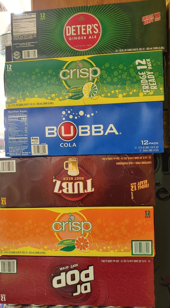 Save-A-Lot 12-pack sodas stacked showing Deters Ginger Ale Crisp Orange Lemon Lime Bubba Cola Wallpaper
