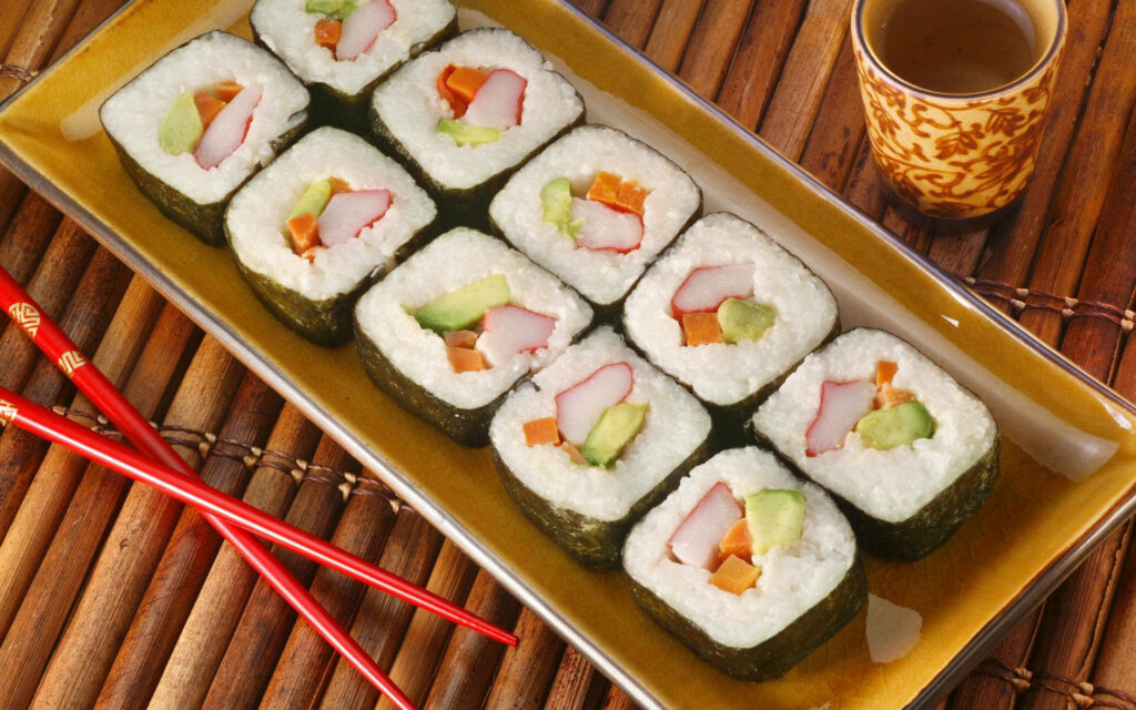 Savoring the Quintessential Japanese Experience: Indulging in Exquisite Sushi Delights amidst a Serene Cultural Tapestry Wallpaper