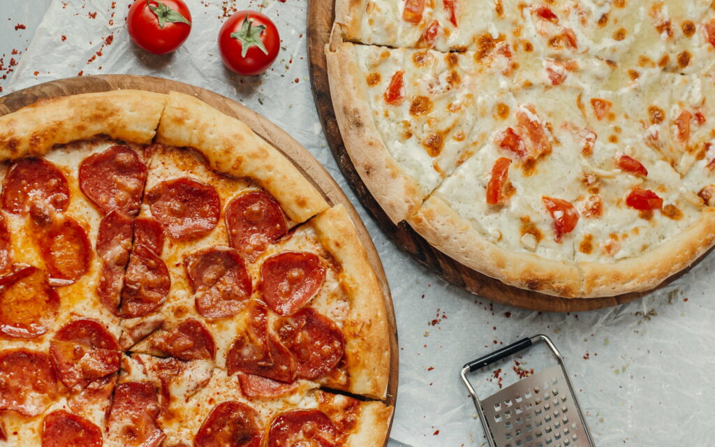 Deliciously Loaded: Tempting Pepperoni Feast on a Crispy Pizza Canvas! Wallpaper