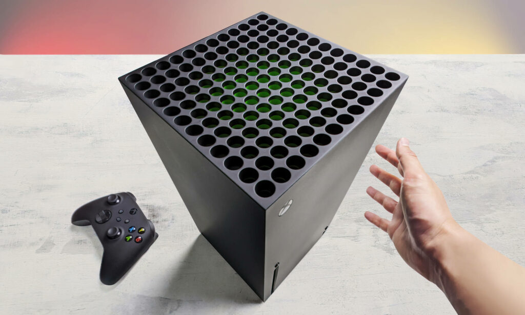 Hand Comparing Xbox Series X Console and Controller Wallpaper