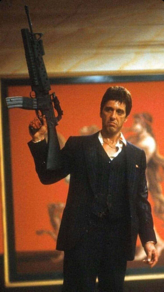 Scarface Tony Montana holding rifle intense iconic crime film wallpaper background image