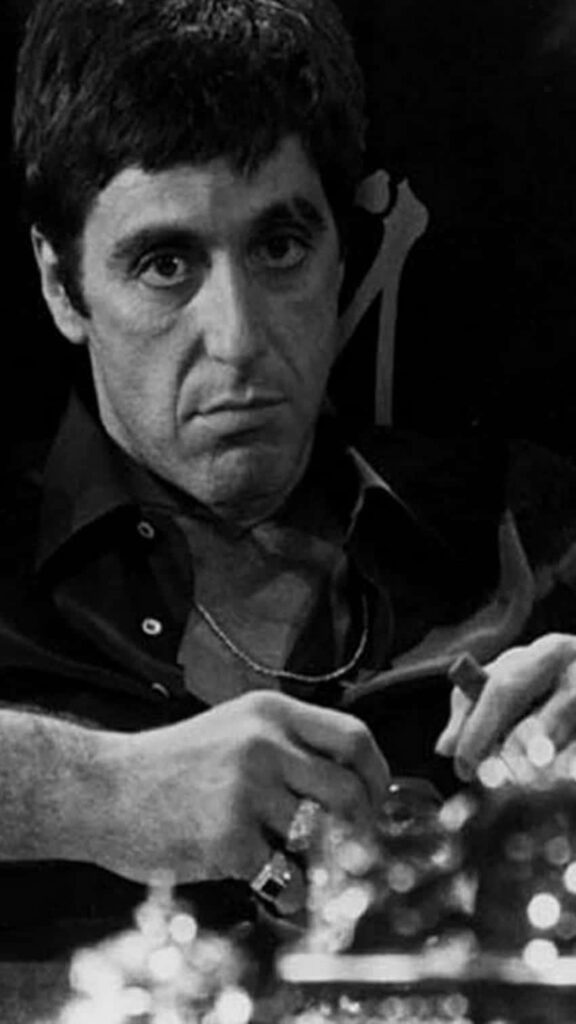Scarface poster wallpaper featuring Tony Montana intense pose gritty dramatic film background