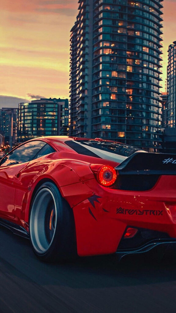 Cruising in Style: A Ferrari 458 Gracefully Capturing the City Lights at Twilight Wallpaper