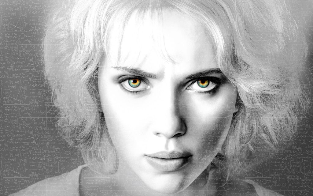 Close-up of Scarlett Johansson as Lucy with intense gaze and math equations background wallpaper